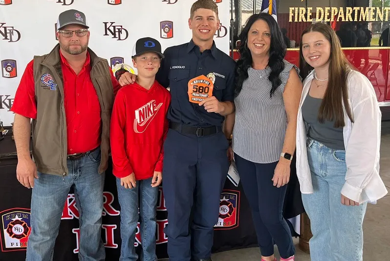 The Fenoglio family, five people standing together at a fire department event